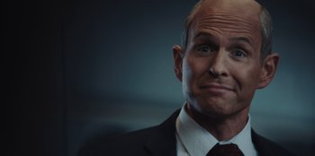Movie still from “BlackBerry” (2023), directed by Matt Johnson – A man in a black suit and a red tie; Close Up shot, Over the shoulder angle