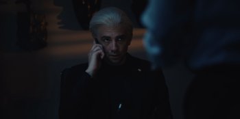 Movie still from “BlackBerry” (2023), directed by Matt Johnson – A man with white hair talking on a cell phone; Close Up shot, Over the shoulder angle