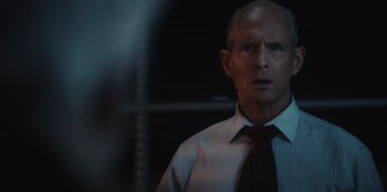Movie still from “BlackBerry” (2023), directed by Matt Johnson – A man wearing a white shirt and a red tie; Close Up shot, Over the shoulder angle