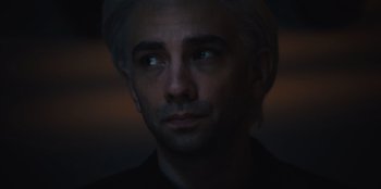 Movie still from “BlackBerry” (2023), directed by Matt Johnson – A person wearing a black shirt; Close Up shot, High angle