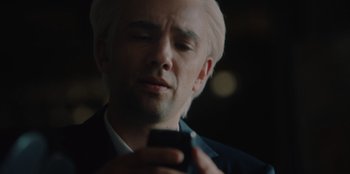 Movie still from “BlackBerry” (2023), directed by Matt Johnson – A person using a cell phone; Close Up shot, High angle