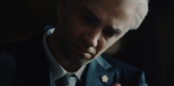 Movie still from “BlackBerry” (2023), directed by Matt Johnson – A person wearing a suit and tie; Extreme Close Up shot, High angle