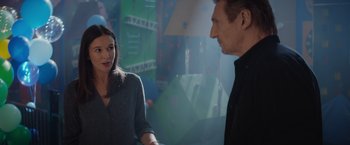 Movie still from “Blacklight” (2022), directed by Mark Williams – A man and a woman standing next to each other; Medium shot, Over the shoulder angle