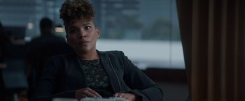 Movie still from “Blacklight” (2022), directed by Mark Williams – A woman sitting in front of a laptop computer; Close Up shot, Over the shoulder angle