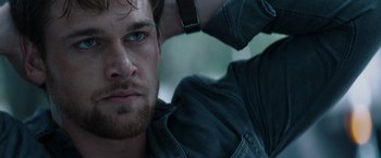 Movie still from “Blacklight” (2022), directed by Mark Williams – A man's face with a beard; Close Up shot, Low angle