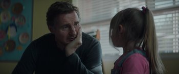 Movie still from “Blacklight” (2022), directed by Mark Williams – A man and a little girl are talking to each other; Close Up shot, Over the shoulder angle