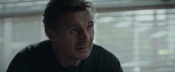 Movie still from “Blacklight” (2022), directed by Mark Williams – A person looking at the camera; Close Up shot, Over the shoulder angle