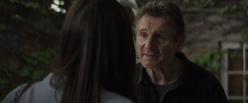 Movie still from “Blacklight” (2022), directed by Mark Williams – A man and a woman looking at one another; Close Up shot, Over the shoulder angle