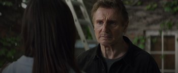 Movie still from “Blacklight” (2022), directed by Mark Williams – A man and a woman looking at one another; Close Up shot, Over the shoulder angle