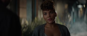 Movie still from “Blacklight” (2022), directed by Mark Williams – A person wearing a jacket; Close Up shot, Over the shoulder angle