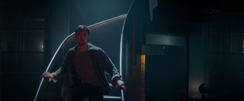 Movie still from “Blacklight” (2022), directed by Mark Williams – A man standing on top of some stairs; Medium shot, Low angle