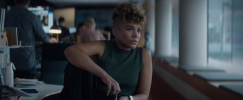 Movie still from “Blacklight” (2022), directed by Mark Williams – A woman sitting in front of a window; Close Up shot, Over the shoulder angle