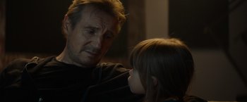 Movie still from “Blacklight” (2022), directed by Mark Williams – A man and a little girl looking at each other; Close Up shot, Over the shoulder angle
