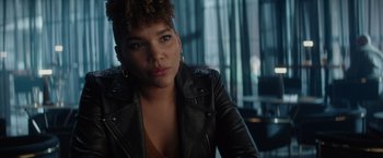 Movie still from “Blacklight” (2022), directed by Mark Williams – A person wearing a leather jacket; Close Up shot, Over the shoulder angle