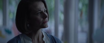 Movie still from “Blacklight” (2022), directed by Mark Williams – A person looking up at something; Close Up shot, Low angle