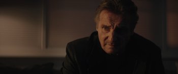 Movie still from “Blacklight” (2022), directed by Mark Williams – An older man is looking into the camera; Close Up shot, Over the shoulder angle