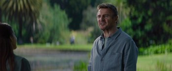 Movie still from “Blacklight” (2022), directed by Mark Williams – Liam neeson wearing a gray shirt; Close Up shot, Low angle