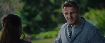 Movie still from “Blacklight” (2022), directed by Mark Williams – A person wearing a blue shirt; Close Up shot, Over the shoulder angle