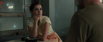 Movie still from “Blade Runner 2049” (2017), directed by Denis Villeneuve – A woman sitting at a table with a bowl in front of her; Close Up shot, Over the shoulder angle