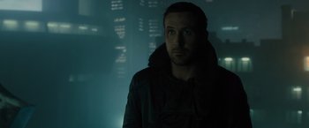 Movie still from “Blade Runner 2049” (2017), directed by Denis Villeneuve – A man standing in a dark room in front of a window; Close Up shot, Low angle