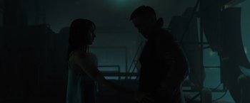 Movie still from “Blade Runner 2049” (2017), directed by Denis Villeneuve – A man and a woman holding hands in the dark; Medium shot, Low angle