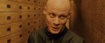 Movie still from “Blade Runner 2049” (2017), directed by Denis Villeneuve – A man with a bald head wearing a black jacket; Close Up shot, High angle