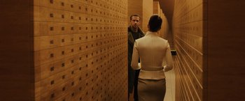 Movie still from “Blade Runner 2049” (2017), directed by Denis Villeneuve – A man and a woman are standing in a hallway; Medium shot, Over the shoulder angle