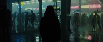 Movie still from “Blade Runner 2049” (2017), directed by Denis Villeneuve – A person standing in the rain at night; Medium shot, Low angle