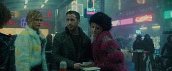 Movie still from “Blade Runner 2049” (2017), directed by Denis Villeneuve – A man and a woman standing next to each other at a table; Medium shot, Over the shoulder angle