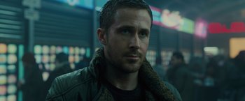 Movie still from “Blade Runner 2049” (2017), directed by Denis Villeneuve – A person wearing a jacket; Close Up shot, Over the shoulder angle