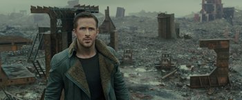 Movie still from “Blade Runner 2049” (2017), directed by Denis Villeneuve – A man standing in the middle of a destroyed city; Close Up shot, Over the shoulder angle