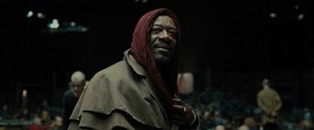 Movie still from “Blade Runner 2049” (2017), directed by Denis Villeneuve – An older man with a red head covering; Close Up shot, Low angle