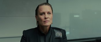 Movie still from “Blade Runner 2049” (2017), directed by Denis Villeneuve – A woman in a black jacket is looking to her left; Close Up shot, Over the shoulder angle