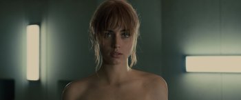 Movie still from “Blade Runner 2049” (2017), directed by Denis Villeneuve – A beautiful young woman with a naked face; Close Up shot, Low angle