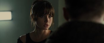 Movie still from “Blade Runner 2049” (2017), directed by Denis Villeneuve – A woman looking at a man in a dark room; Close Up shot, Over the shoulder angle