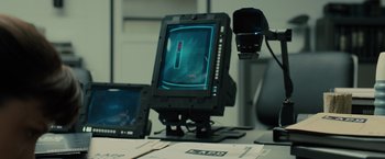 Movie still from “Blade Runner 2049” (2017), directed by Denis Villeneuve – A computer monitor sitting on top of a desk; Extreme Close Up shot, Over the shoulder angle