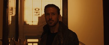 Movie still from “Blade Runner 2049” (2017), directed by Denis Villeneuve – A person wearing a jacket; Close Up shot, Low angle