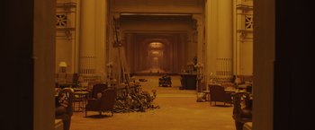 Movie still from “Blade Runner 2049” (2017), directed by Denis Villeneuve – An empty room in a building with a lot of furniture; Extreme Wide shot, High angle