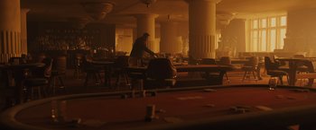 Movie still from “Blade Runner 2049” (2017), directed by Denis Villeneuve – A man standing at a table in a restaurant; Wide shot, High angle
