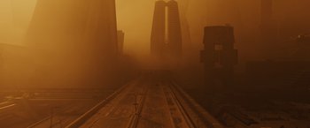 Movie still from “Blade Runner 2049” (2017), directed by Denis Villeneuve – A train track in the middle of a foggy city street; Extreme Wide shot, High angle