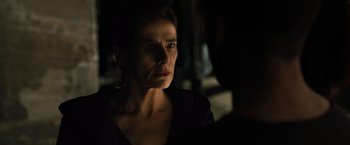 Movie still from “Blade Runner 2049” (2017), directed by Denis Villeneuve – A person looking at something in the dark; Close Up shot, Over the shoulder angle