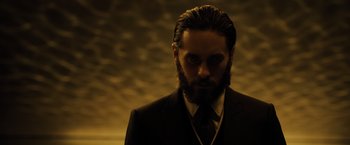 Movie still from “Blade Runner 2049” (2017), directed by Denis Villeneuve – A bearded man in a suit and tie; Close Up shot, Low angle
