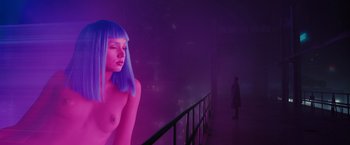 Movie still from “Blade Runner 2049” (2017), directed by Denis Villeneuve – A woman with blue hair standing next to a railing; Close Up shot, Over the shoulder angle