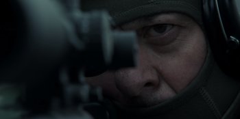 Movie still from “Blood Red Sky” (2021), directed by Peter Thorwarth – A man's face as he looks through a rifle scope; Extreme Close Up shot, Over the shoulder angle