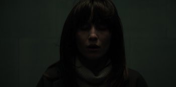 Movie still from “Blood Red Sky” (2021), directed by Peter Thorwarth – A woman with her eyes closed in the dark; Close Up shot, Low angle