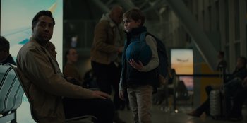 Movie still from “Blood Red Sky” (2021), directed by Peter Thorwarth – A young boy holding a blue ball in his hand; Medium shot, Over the shoulder angle