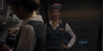 Movie still from “Blood Red Sky” (2021), directed by Peter Thorwarth – A woman wearing a hat and a vest standing in front of another woman; Medium shot, Over the shoulder angle