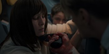 Movie still from “Blood Red Sky” (2021), directed by Peter Thorwarth – A woman is holding a camera and a man is holding a camera; Close Up shot, High angle