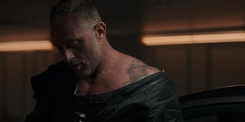 Movie still from “Blood Red Sky” (2021), directed by Peter Thorwarth – A person with a tattoo on his shoulder; Close Up shot, Low angle