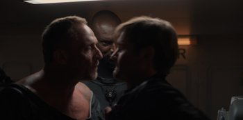 Movie still from “Blood Red Sky” (2021), directed by Peter Thorwarth – A couple of men standing next to each other; Close Up shot, Over the shoulder angle